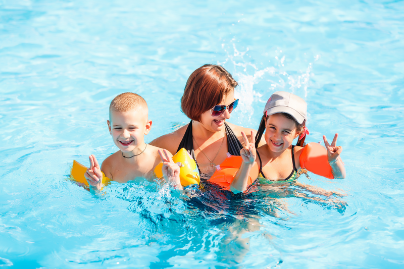 family swimming in the pool at Olde Gatlinburg place